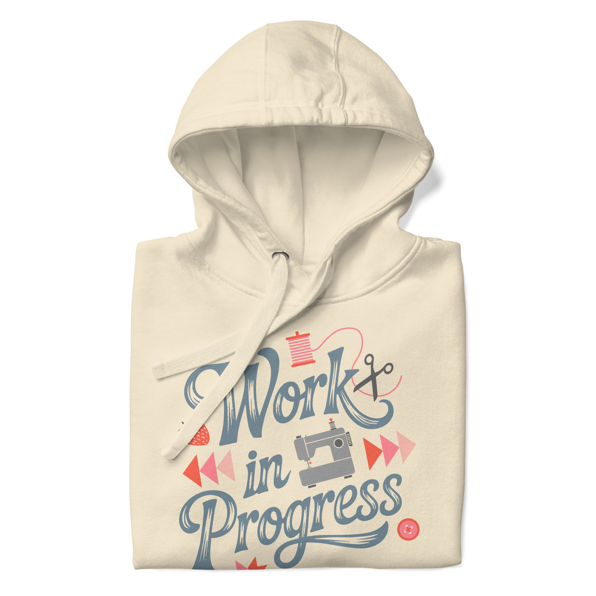 Work in Progress sewing design with flying geese, sewing machine, strawberry and thread spool on a pullover hoodie in vintage white, folded close-up of the design – Kate Spain design for Pat Sloan