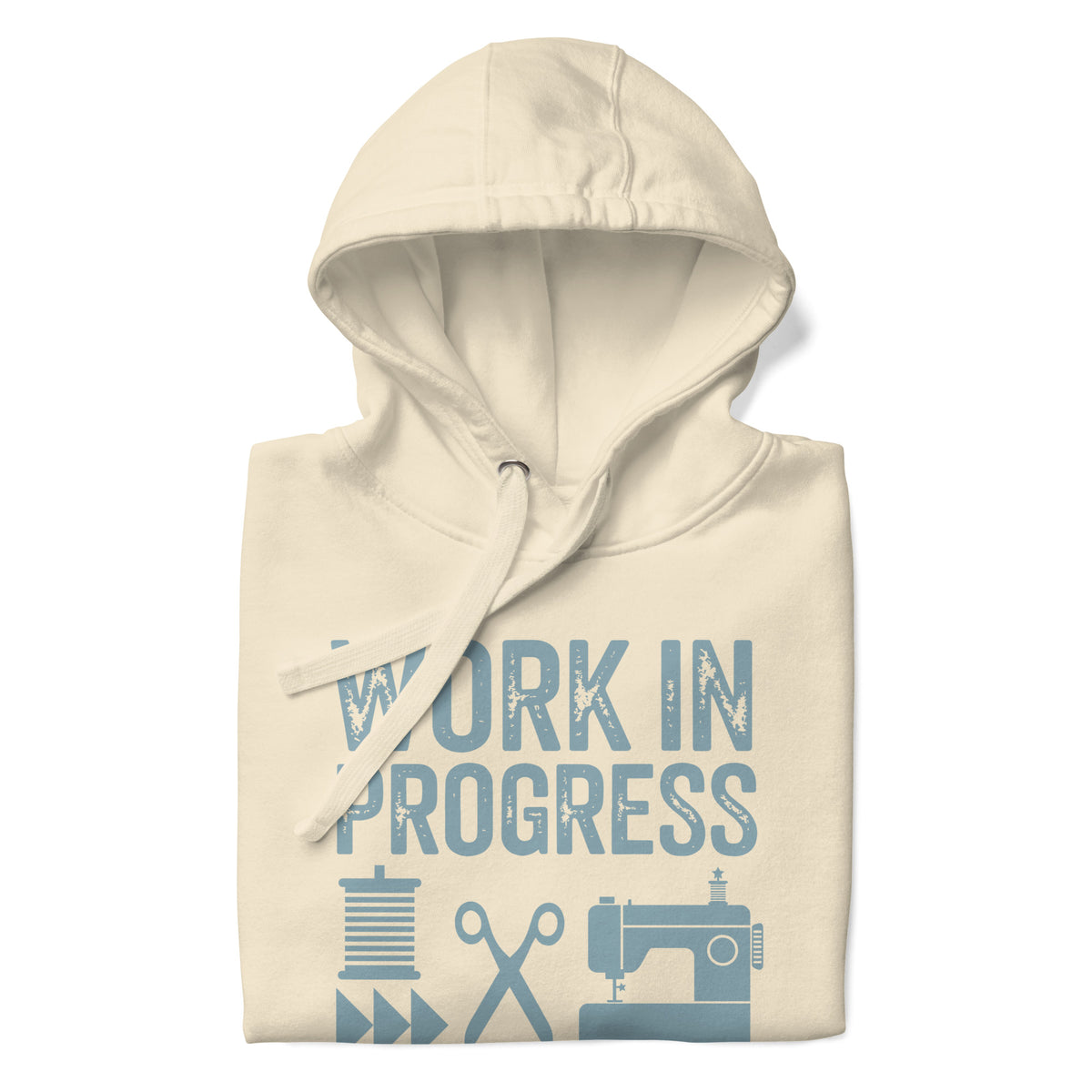 Work in Progress Mod distressed lettering with thread, scissors and sewing machine on a pullover hoodie in vintage white, folded close-up of the design – Kate Spain design for Pat Sloan