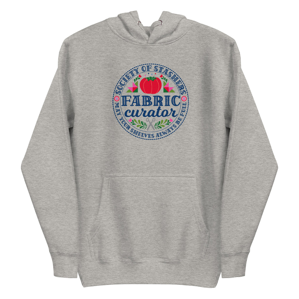 Fabric Curator Society of Stashers badge with a tomato pincushion on a pullover hoodie in athletic grey, front view – Kate Spain design for Pat Sloan