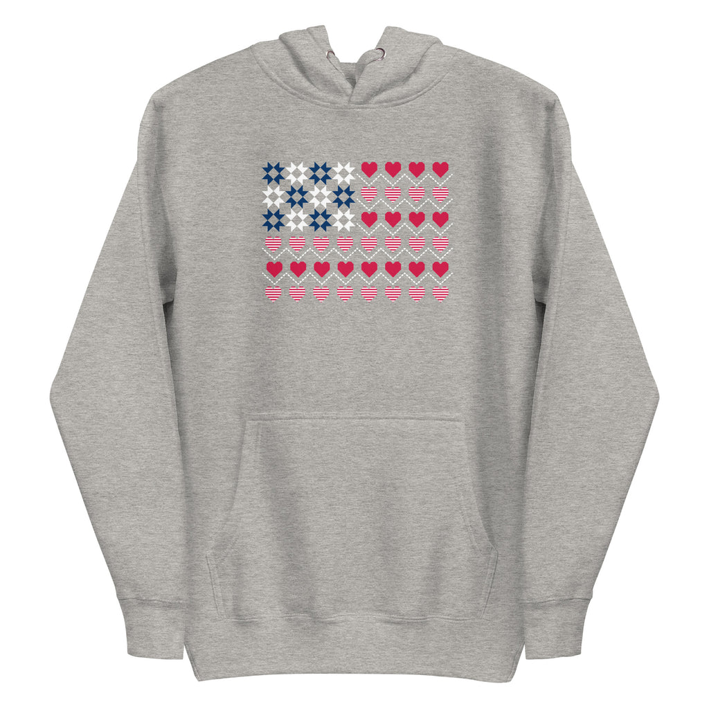 United We Quilt patchwork flag with quilt-block stars and heart stripes on a pullover hoodie in athletic grey, front view – Kate Spain design for Pat Sloan
