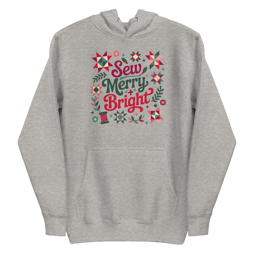 Sew Merry + Bright lettering with quilt-block stars, holly and a thread spool on a pullover hoodie in athletic grey, front view – Kate Spain design for Pat Sloan
