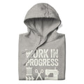 Work in Progress Mod distressed lettering with thread, scissors and sewing machine on a pullover hoodie in athletic grey, folded close-up of the design – Kate Spain design for Pat Sloan
