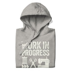Work in Progress Mod distressed lettering with thread, scissors and sewing machine on a pullover hoodie in athletic grey, folded close-up of the design – Kate Spain design for Pat Sloan