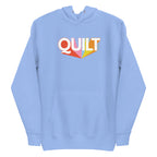 Moda QUILT logo with orange, pink, blue and yellow rays on a premium hoodie in Carolina blue, front view – Kate Spain design