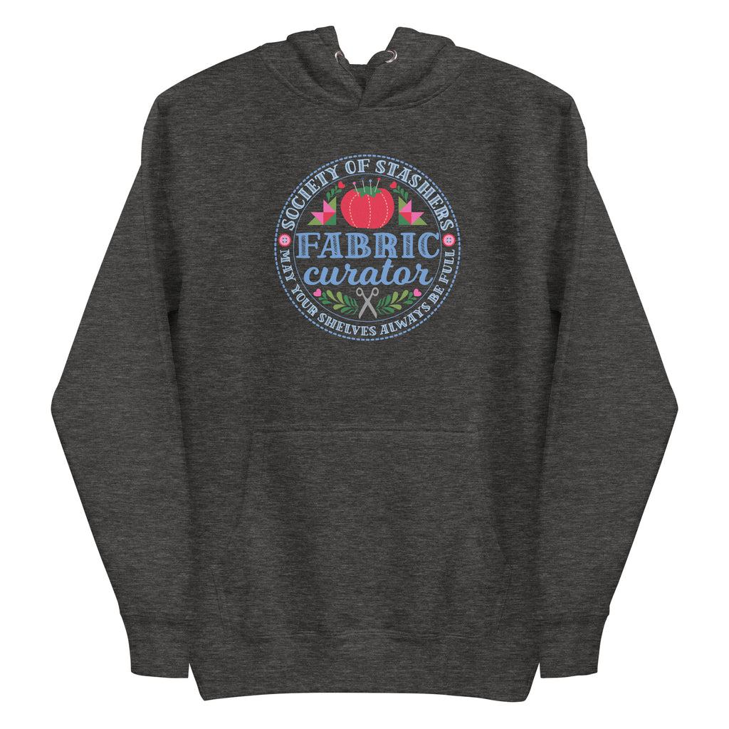 Fabric Curator Society of Stashers badge with a tomato pincushion on a pullover hoodie in charcoal grey, front view – Kate Spain design for Pat Sloan