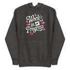 Work in Progress sewing design with flying geese, sewing machine, strawberry and thread spool on a pullover hoodie in charcoal grey, front view – Kate Spain design for Pat Sloan