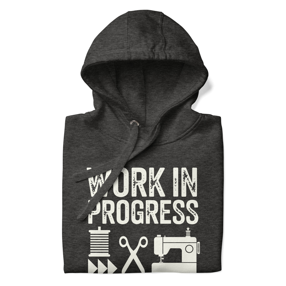Work in Progress Mod distressed lettering with thread, scissors and sewing machine on a pullover hoodie in charcoal grey, folded close-up of the design – Kate Spain design for Pat Sloan