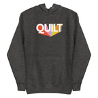 Moda QUILT logo with orange, pink, blue and yellow rays on a premium hoodie in charcoal grey, front view – Kate Spain design