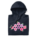 Pink GeoFlora hexagon flowers in pinks, mauves and sage on a pullover hoodie in navy, folded close-up of the design – Kate Spain design for Pat Sloan