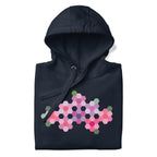 Pink GeoFlora hexagon flowers in pinks, mauves and sage on a pullover hoodie in navy, folded close-up of the design – Kate Spain design for Pat Sloan
