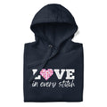 Love in Every Stitch distressed lettering on a pullover hoodie in navy, folded close-up of the design – Kate Spain design for Pat Sloan