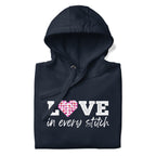 Love in Every Stitch distressed lettering on a pullover hoodie in navy, folded close-up of the design – Kate Spain design for Pat Sloan