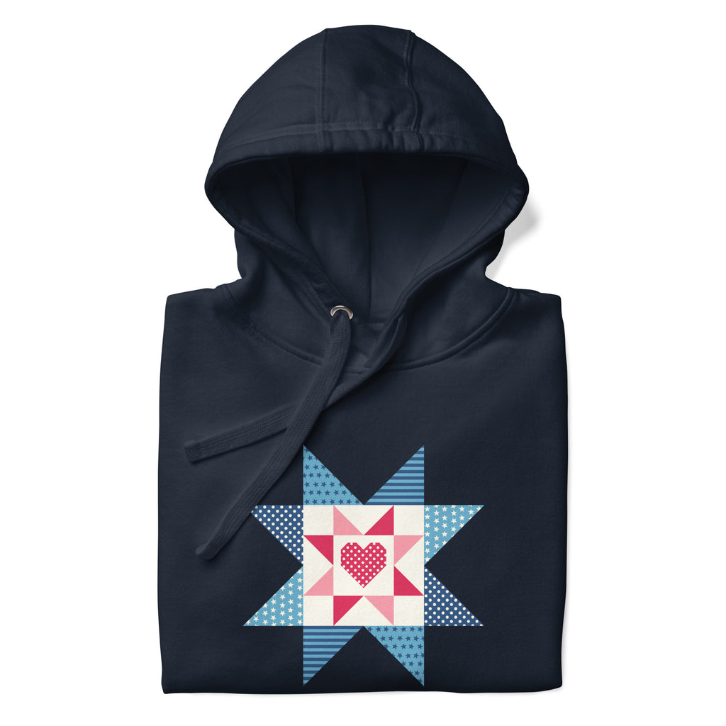 Liberty Love star quilt block with a heart in red, white and blue on a pullover hoodie in navy, folded close-up of the design – Kate Spain design for Pat Sloan