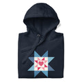 Liberty Love star quilt block with a heart in red, white and blue on a pullover hoodie in navy, folded close-up of the design – Kate Spain design for Pat Sloan