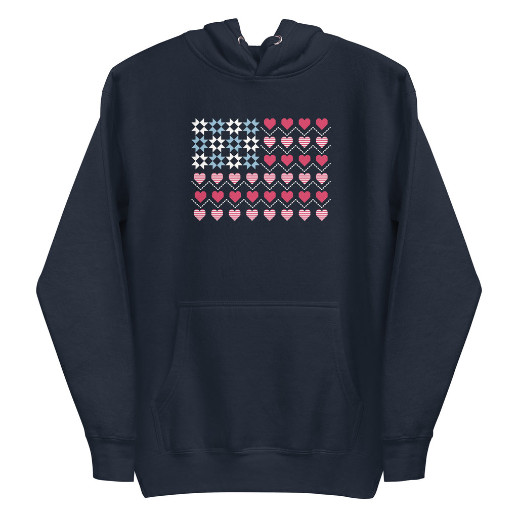 United We Quilt patchwork flag with quilt-block stars and heart stripes on a pullover hoodie in navy, front view – Kate Spain design for Pat Sloan