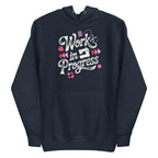 Work in Progress sewing design with flying geese, sewing machine, strawberry and thread spool on a pullover hoodie in navy, front view – Kate Spain design for Pat Sloan