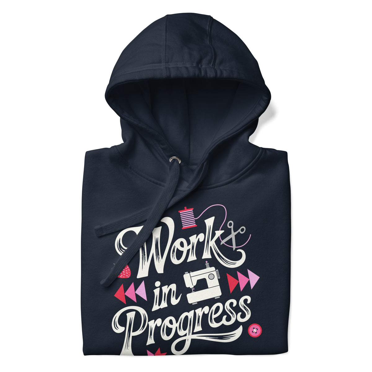 Work in Progress sewing design with flying geese, sewing machine, strawberry and thread spool on a pullover hoodie in navy, folded close-up of the design – Kate Spain design for Pat Sloan
