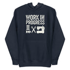 Work in Progress Mod distressed lettering with thread, scissors and sewing machine on a pullover hoodie in navy, front view – Kate Spain design for Pat Sloan