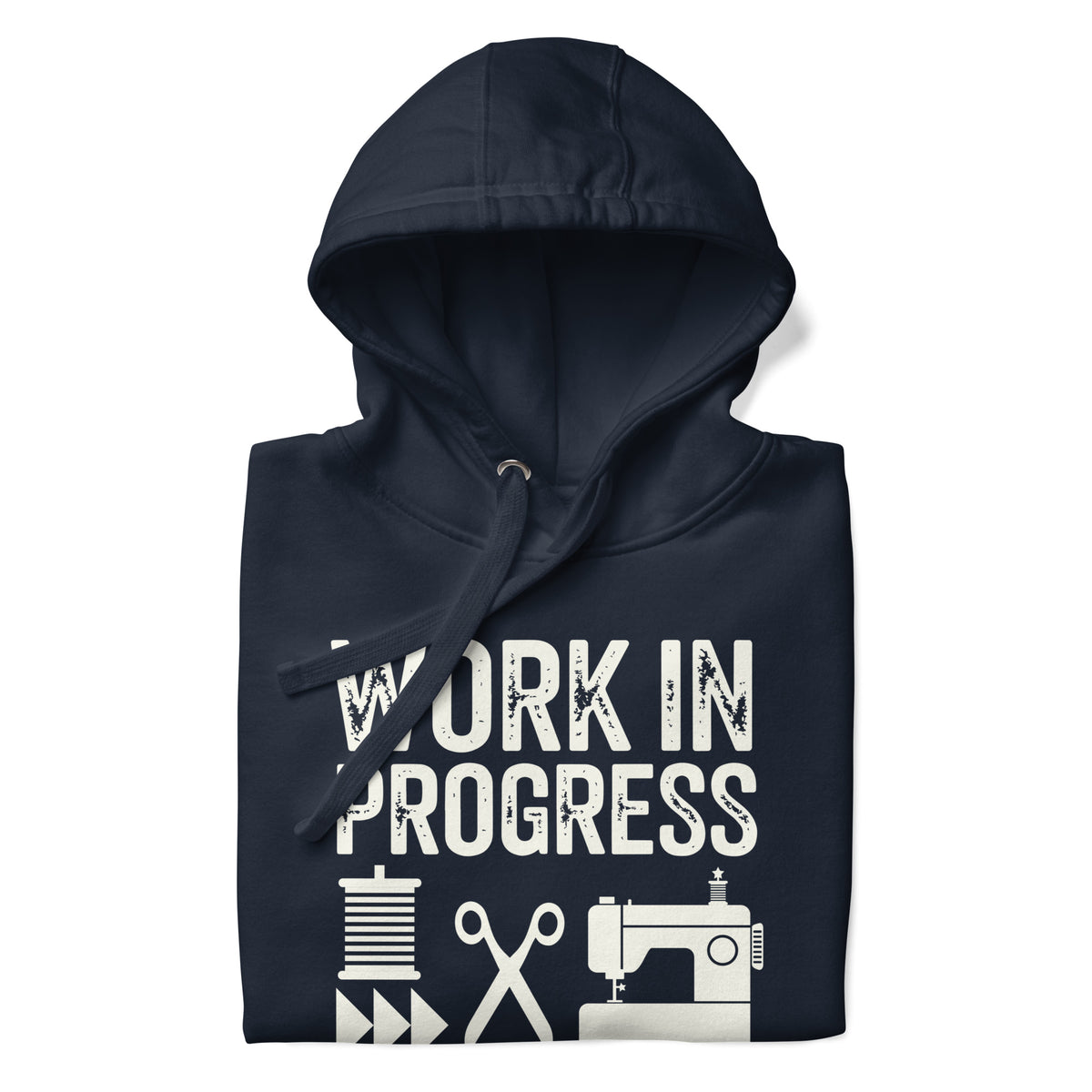 Work in Progress Mod distressed lettering with thread, scissors and sewing machine on a pullover hoodie in navy, folded close-up of the design – Kate Spain design for Pat Sloan