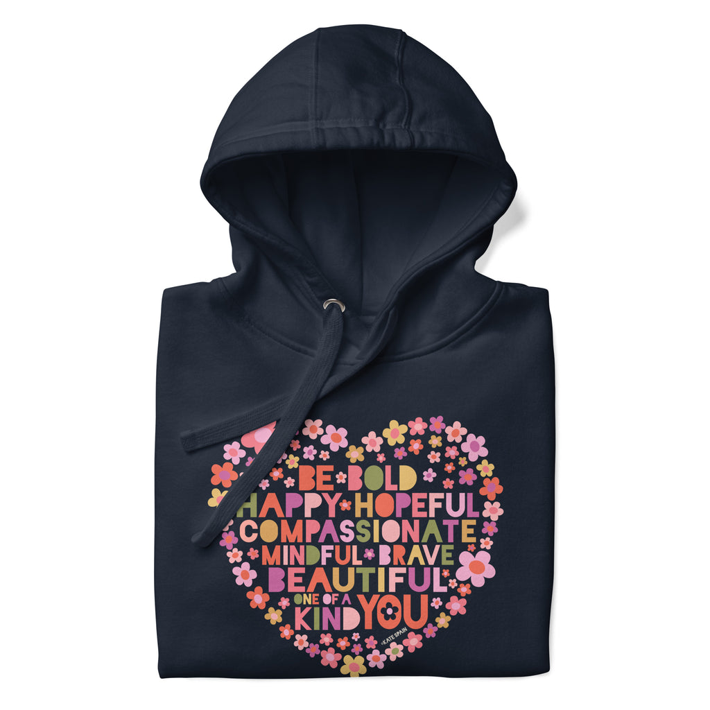 Be You floral heart of inspirational words on a premium hoodie in navy, folded close-up of the design – Kate Spain design