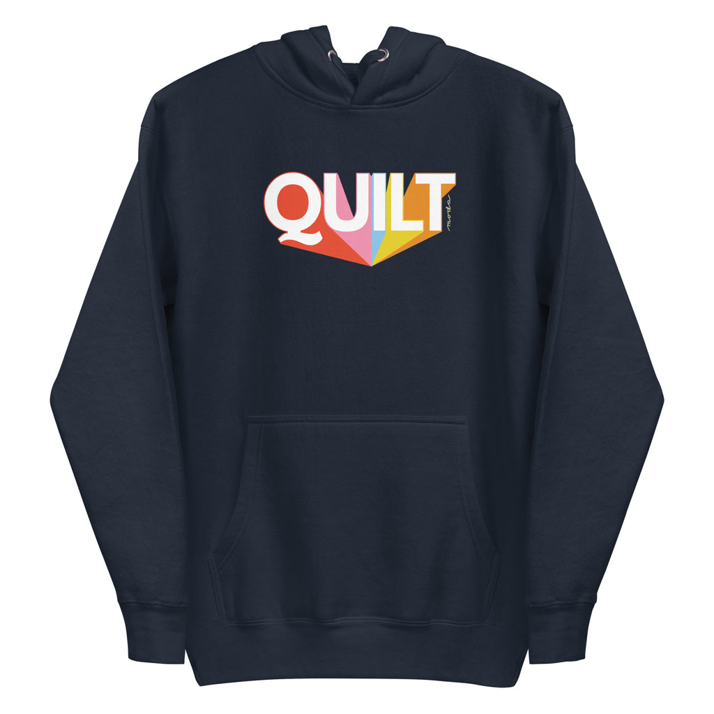 Moda QUILT logo with orange, pink, blue and yellow rays on a premium hoodie in navy, front view – Kate Spain design