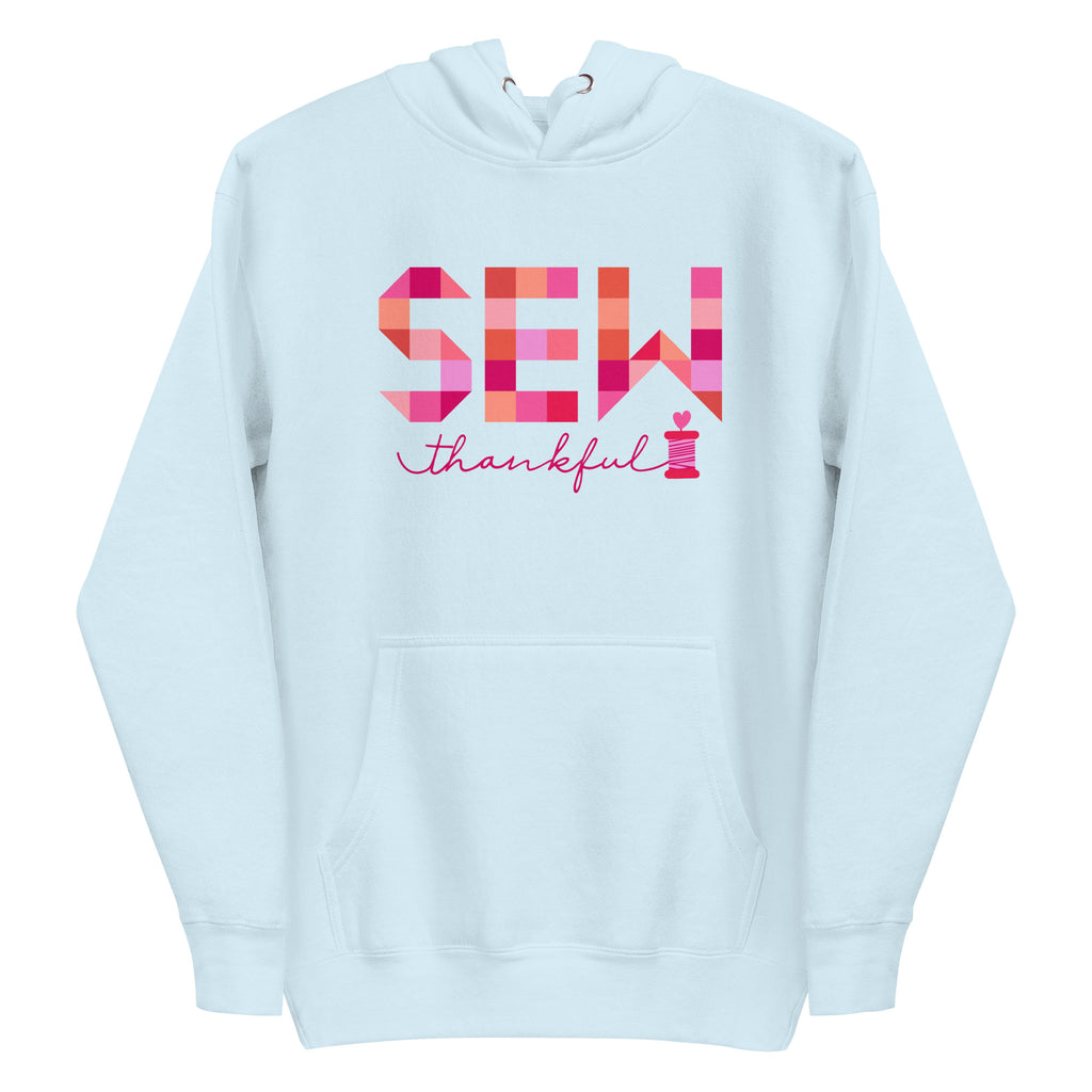 Sew Thankful patchwork lettering with a heart-topped thread spool on a pullover hoodie in sky blue, front view – Kate Spain design for Pat Sloan