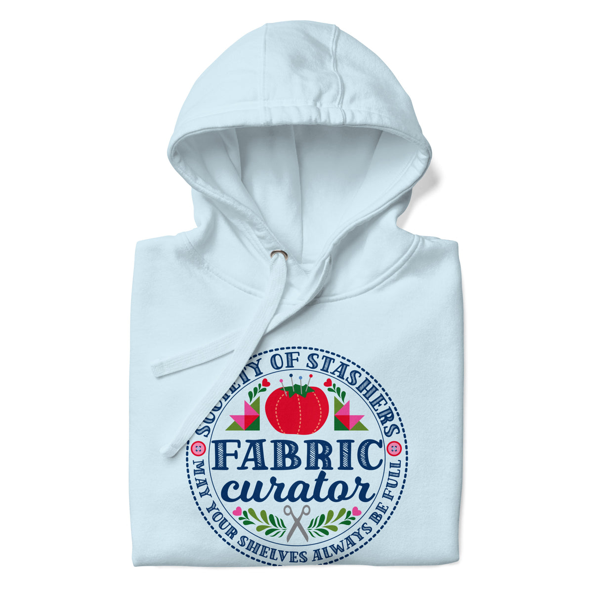 Fabric Curator Society of Stashers badge with a tomato pincushion on a pullover hoodie in sky blue, folded close-up of the design – Kate Spain design for Pat Sloan