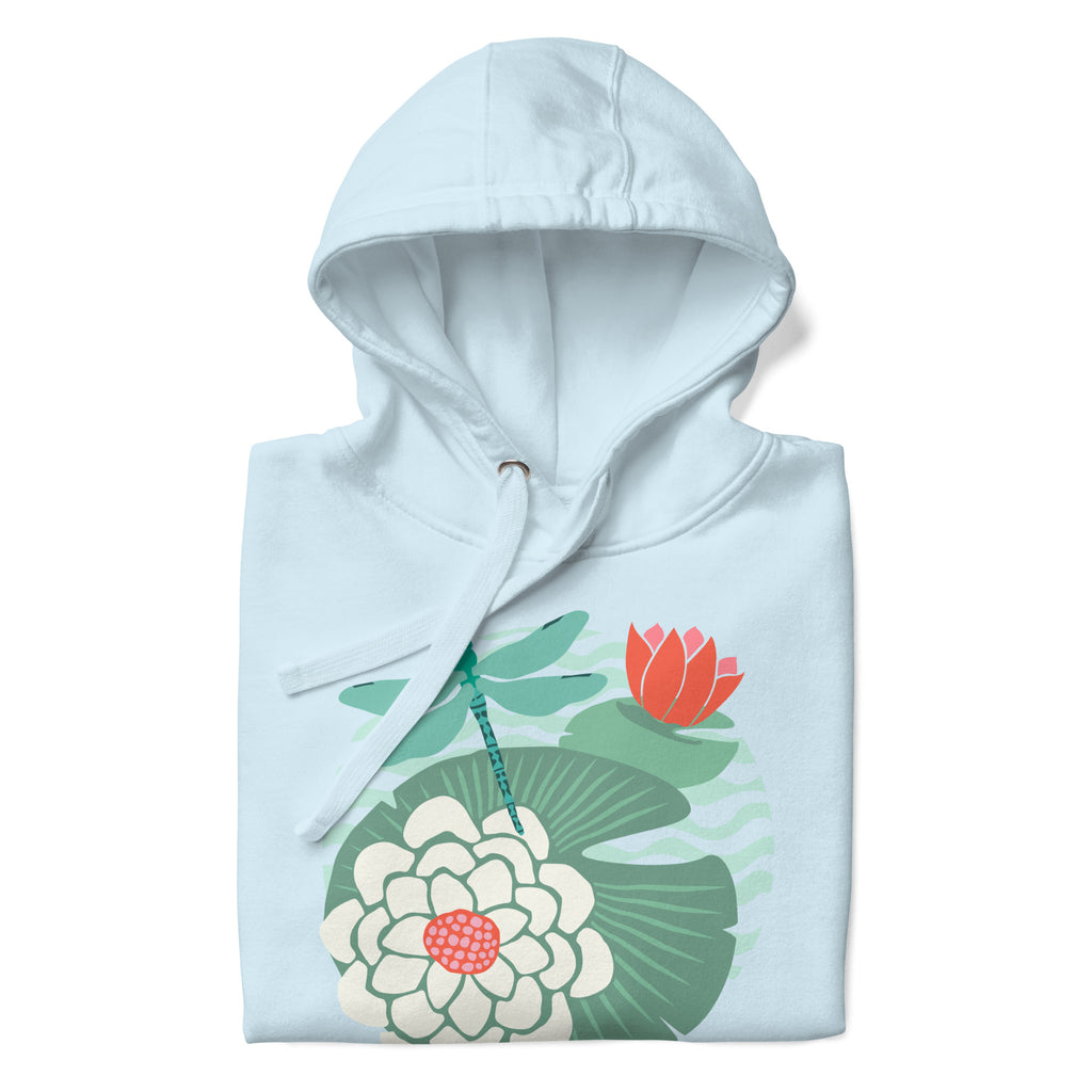 Dragonfly over water lilies and lily pads on a pullover hoodie in sky blue, folded close-up of the design – Kate Spain design