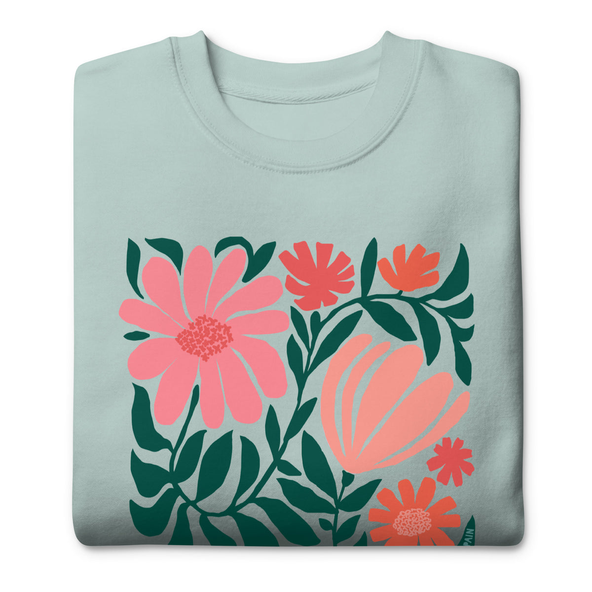 Botanica modern floral design with pink and coral blooms on a crewneck sweatshirt in agave, folded close-up of the design – Kate Spain design
