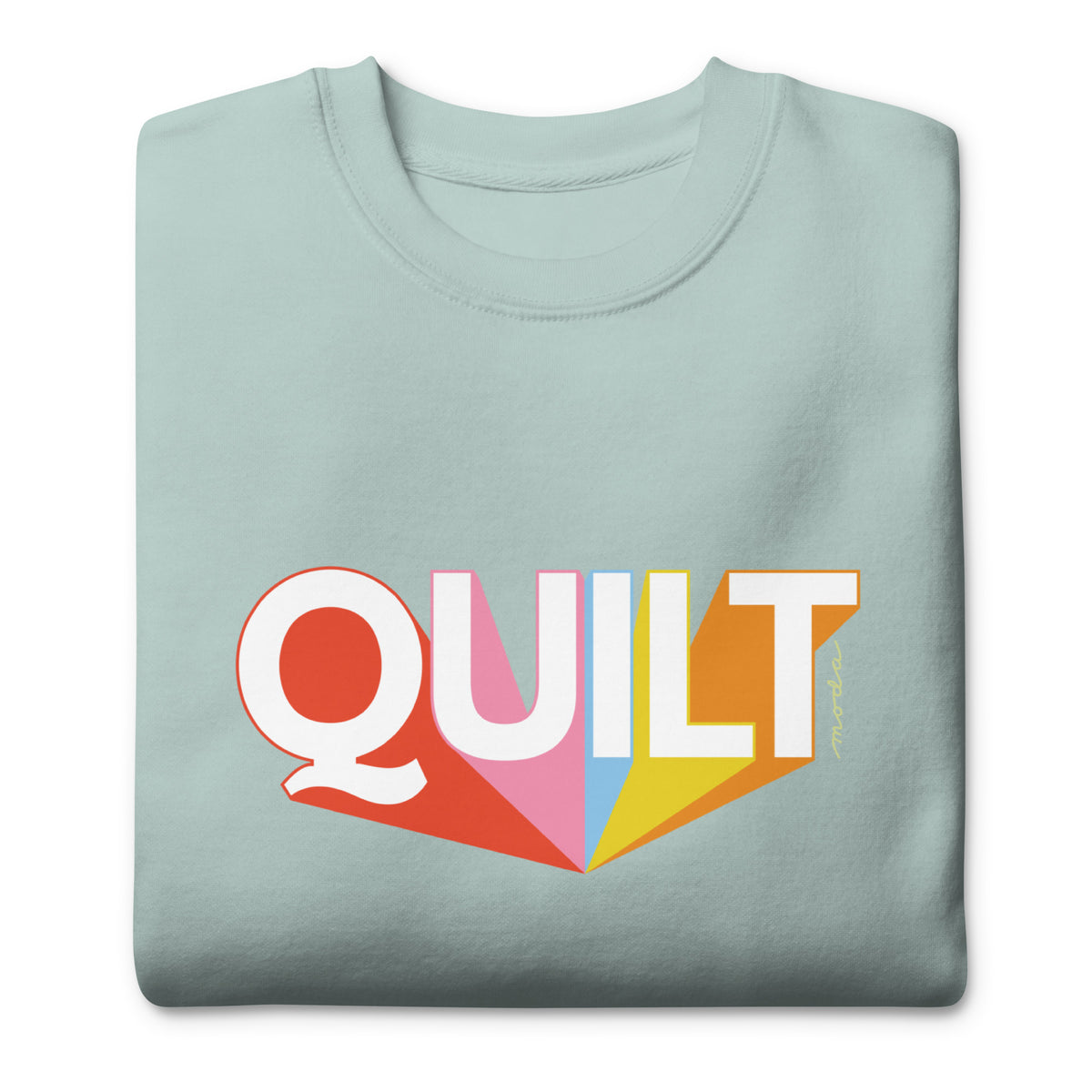 Moda QUILT logo with orange, pink, blue and yellow rays on a premium sweatshirt in agave, folded close-up of the design – Kate Spain design