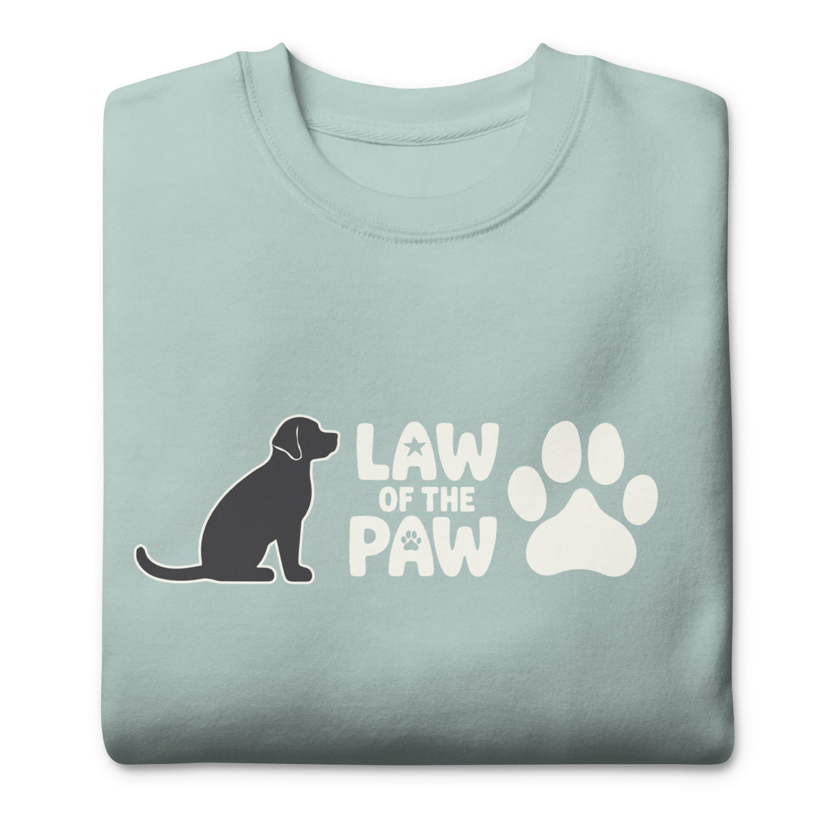 Law of the Paw® logo with seated dog and paw print on a crewneck sweatshirt in agave, folded close-up of the design – Kate Spain design