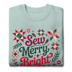 Sew Merry + Bright lettering with quilt stars and holly on a premium sweatshirt in agave, folded close-up of the design – Kate Spain design for Pat Sloan