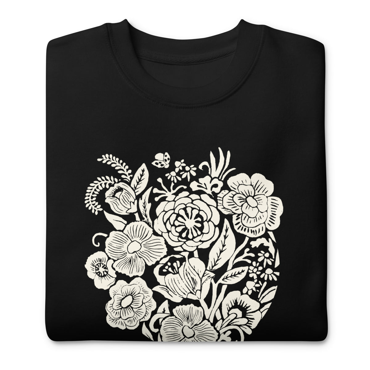 Meadowsweet woodblock-style bouquet of wildflowers on a crewneck sweatshirt in black, folded close-up of the design – Kate Spain design