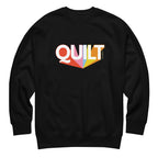 Moda QUILT logo with orange, pink, blue and yellow rays on a premium sweatshirt in black, front view – Kate Spain design