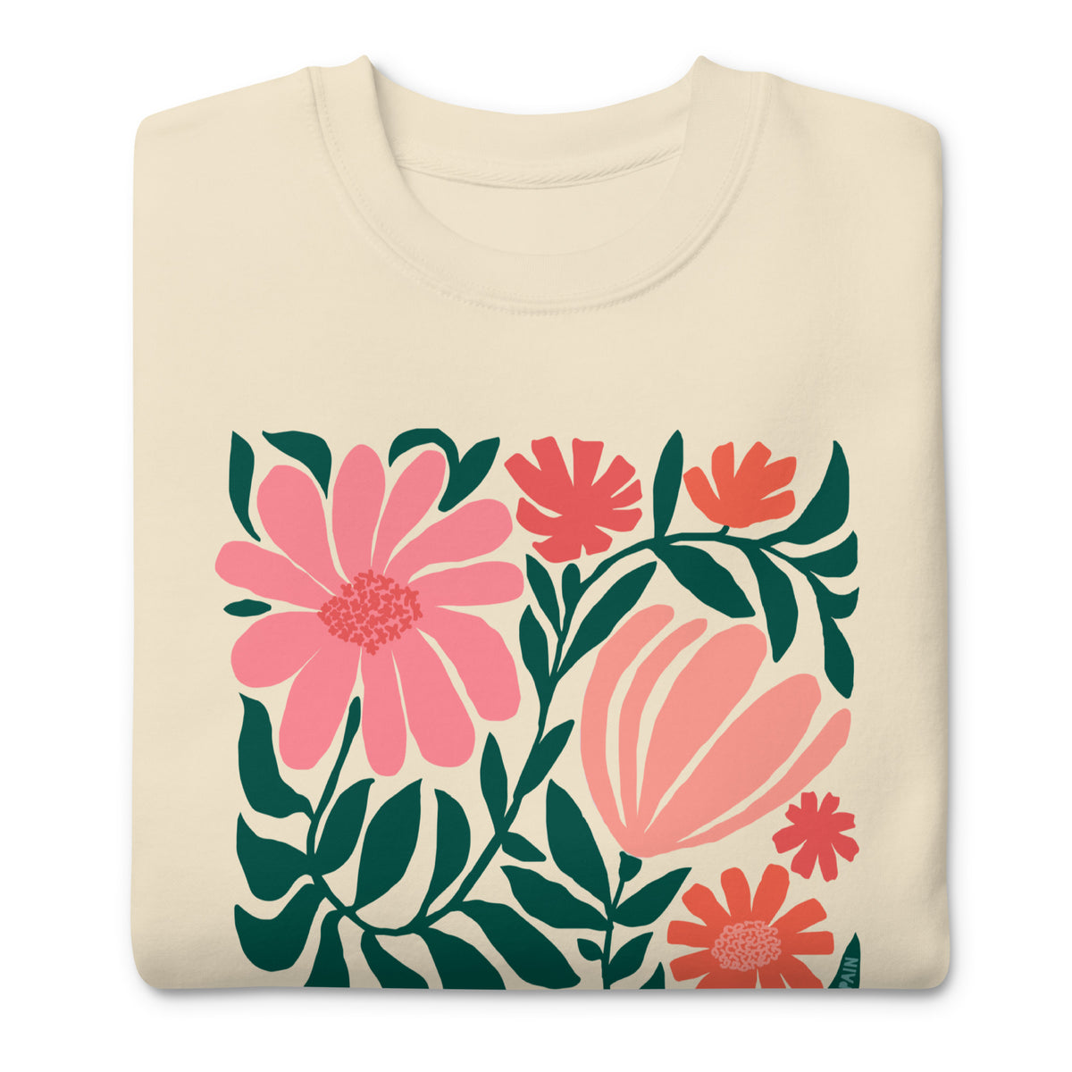 Botanica modern floral design with pink and coral blooms on a crewneck sweatshirt in vintage white, folded close-up of the design – Kate Spain design