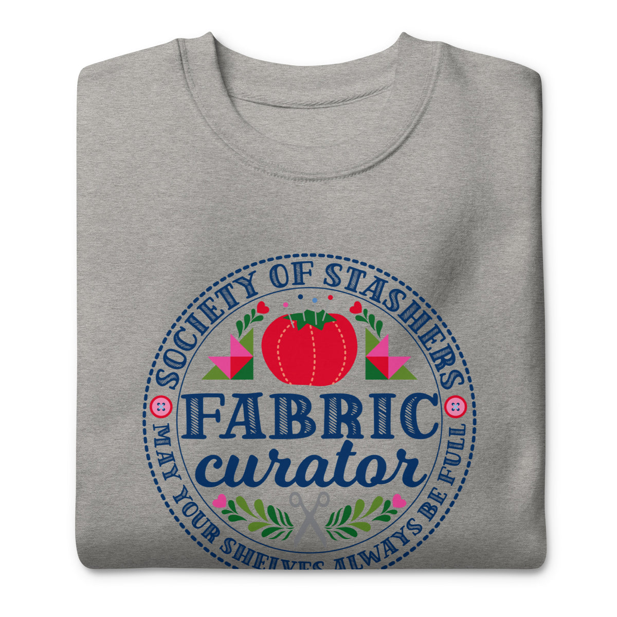 Fabric Curator Society of Stashers badge with a tomato pincushion on a crewneck sweatshirt in athletic grey, folded close-up of the design – Kate Spain design for Pat Sloan