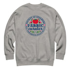Fabric Curator Society of Stashers badge with a tomato pincushion on a crewneck sweatshirt in athletic grey, front view – Kate Spain design for Pat Sloan
