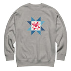 Liberty Love star quilt block with a heart in red, white and blue on a crewneck sweatshirt in athletic grey, front view – Kate Spain design for Pat Sloan