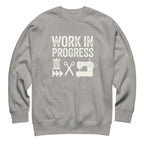 Work in Progress lettering with sewing icons on a premium sweatshirt in athletic grey, front view – Kate Spain design for Pat Sloan