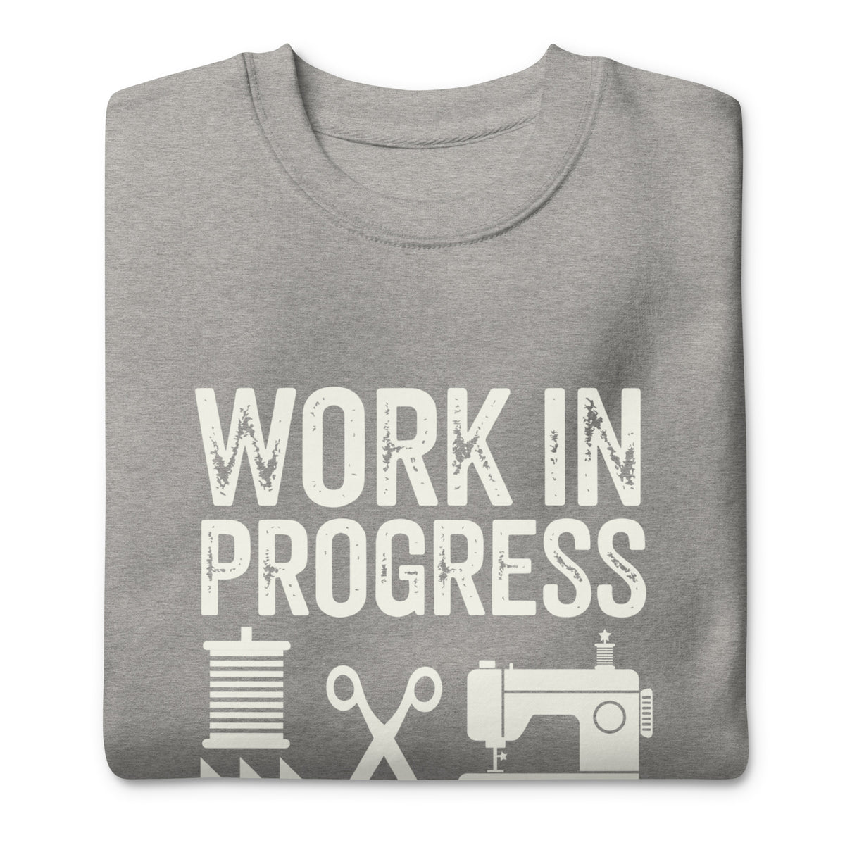 Work in Progress lettering with sewing icons on a premium sweatshirt in athletic grey, folded close-up of the design – Kate Spain design for Pat Sloan