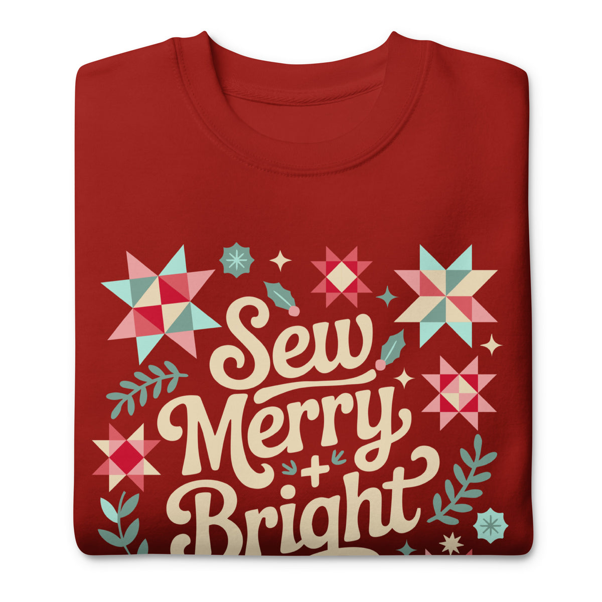 Sew Merry + Bright lettering with quilt stars and holly on a premium sweatshirt in cardinal red, folded close-up of the design – Kate Spain design for Pat Sloan