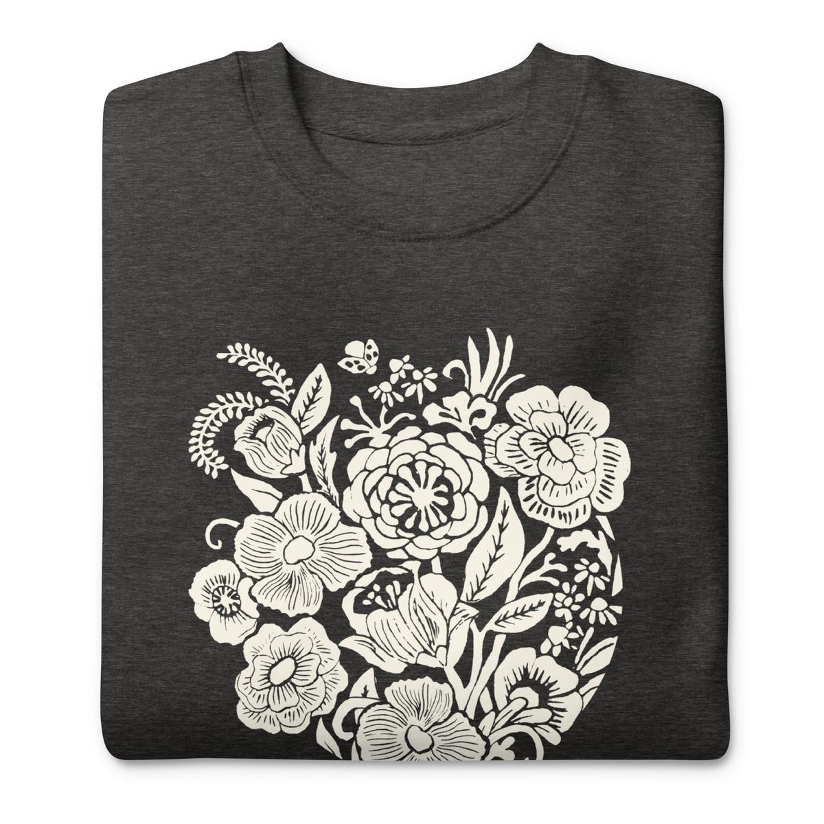 Meadowsweet woodblock-style bouquet of wildflowers on a crewneck sweatshirt in charcoal grey, folded close-up of the design – Kate Spain design