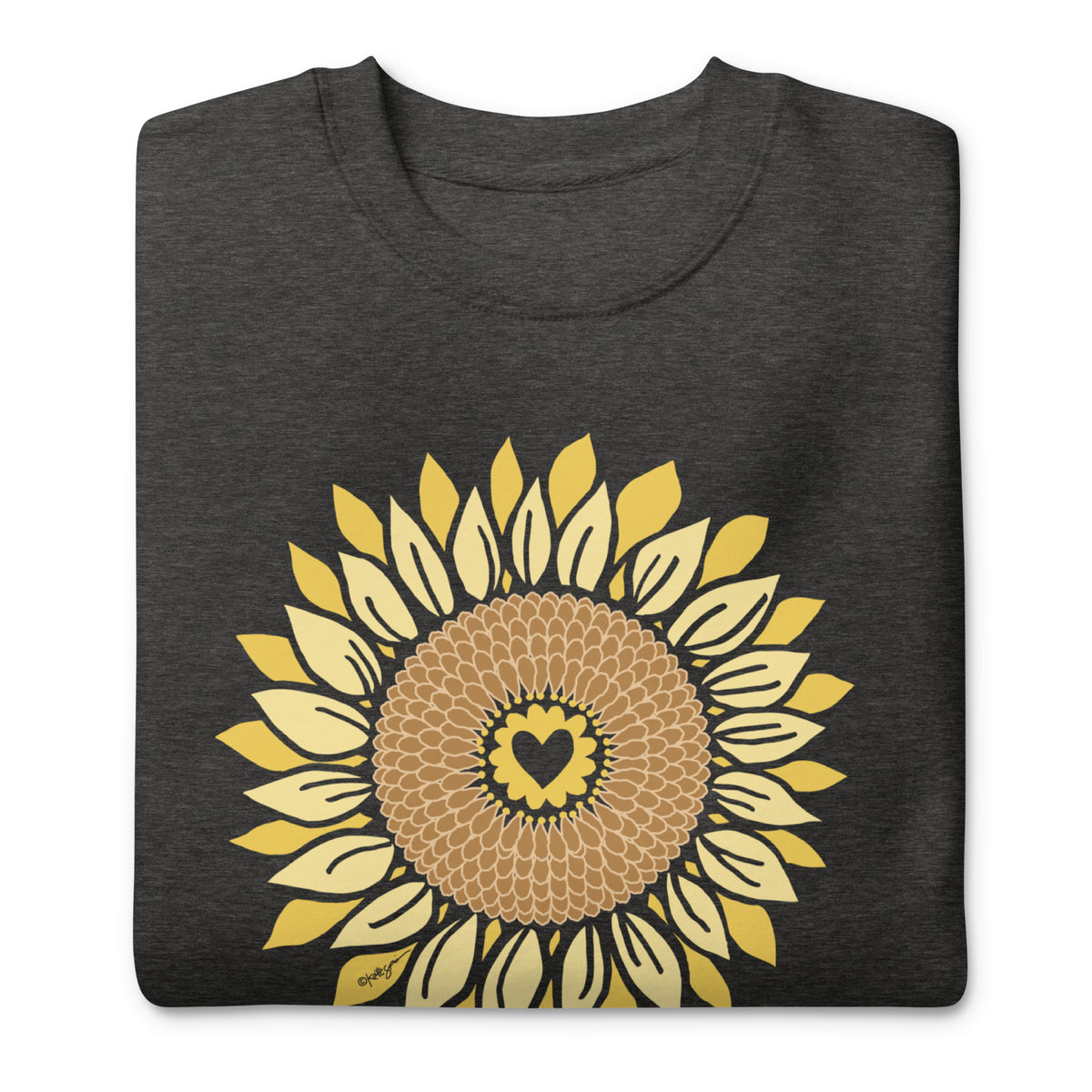 Golden sunflower with a heart center on a crewneck sweatshirt in charcoal grey, folded close-up of the design – Sunflowers in My Heart by Kate Spain