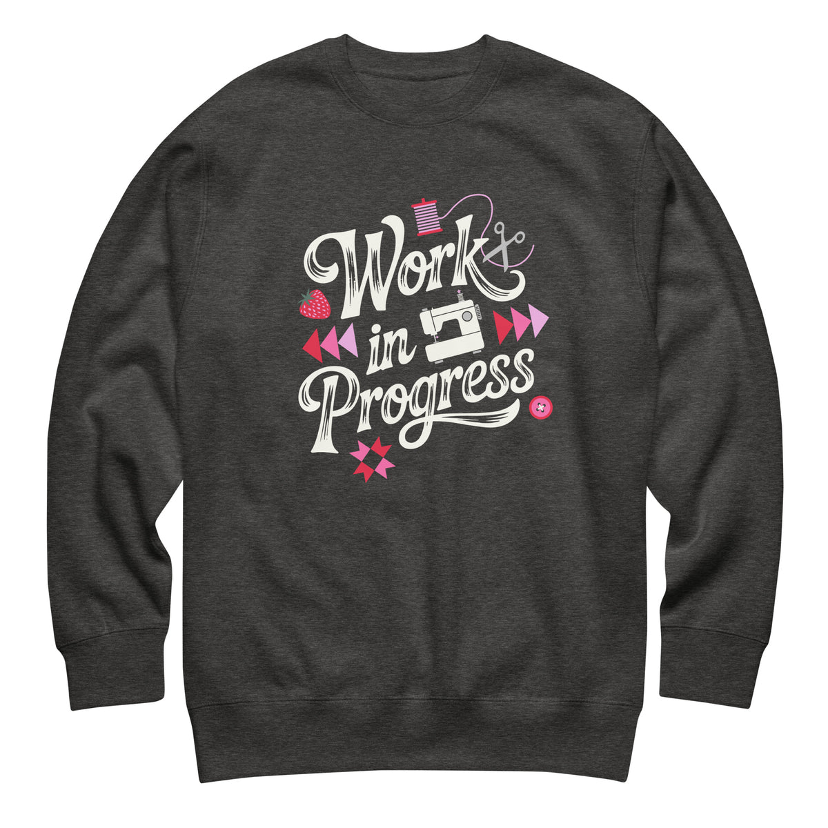 Work in Progress script lettering with sewing icons on a premium sweatshirt in charcoal grey, front view – Kate Spain design for Pat Sloan