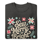 Sew Merry + Bright lettering with quilt stars and holly on a premium sweatshirt in charcoal grey, folded close-up of the design – Kate Spain design for Pat Sloan