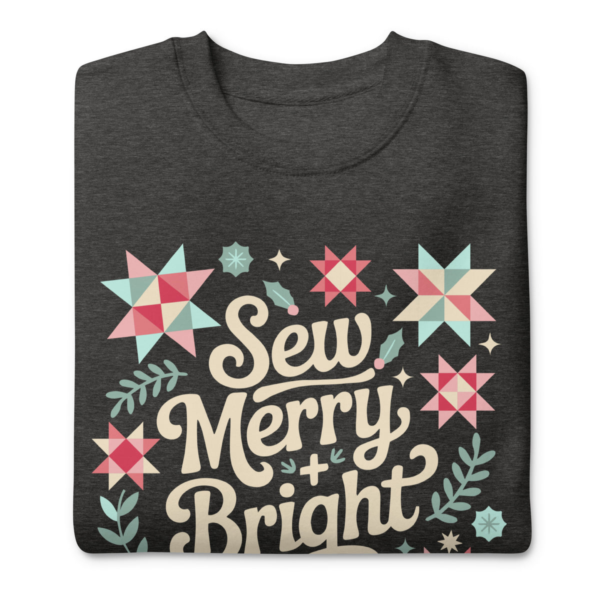 Sew Merry + Bright lettering with quilt stars and holly on a premium sweatshirt in charcoal grey, folded close-up of the design – Kate Spain design for Pat Sloan