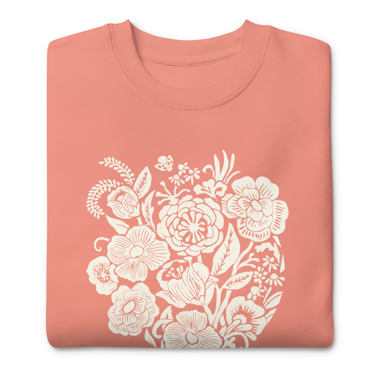 Meadowsweet woodblock-style bouquet of wildflowers on a crewneck sweatshirt in dusty rose, folded close-up of the design – Kate Spain design