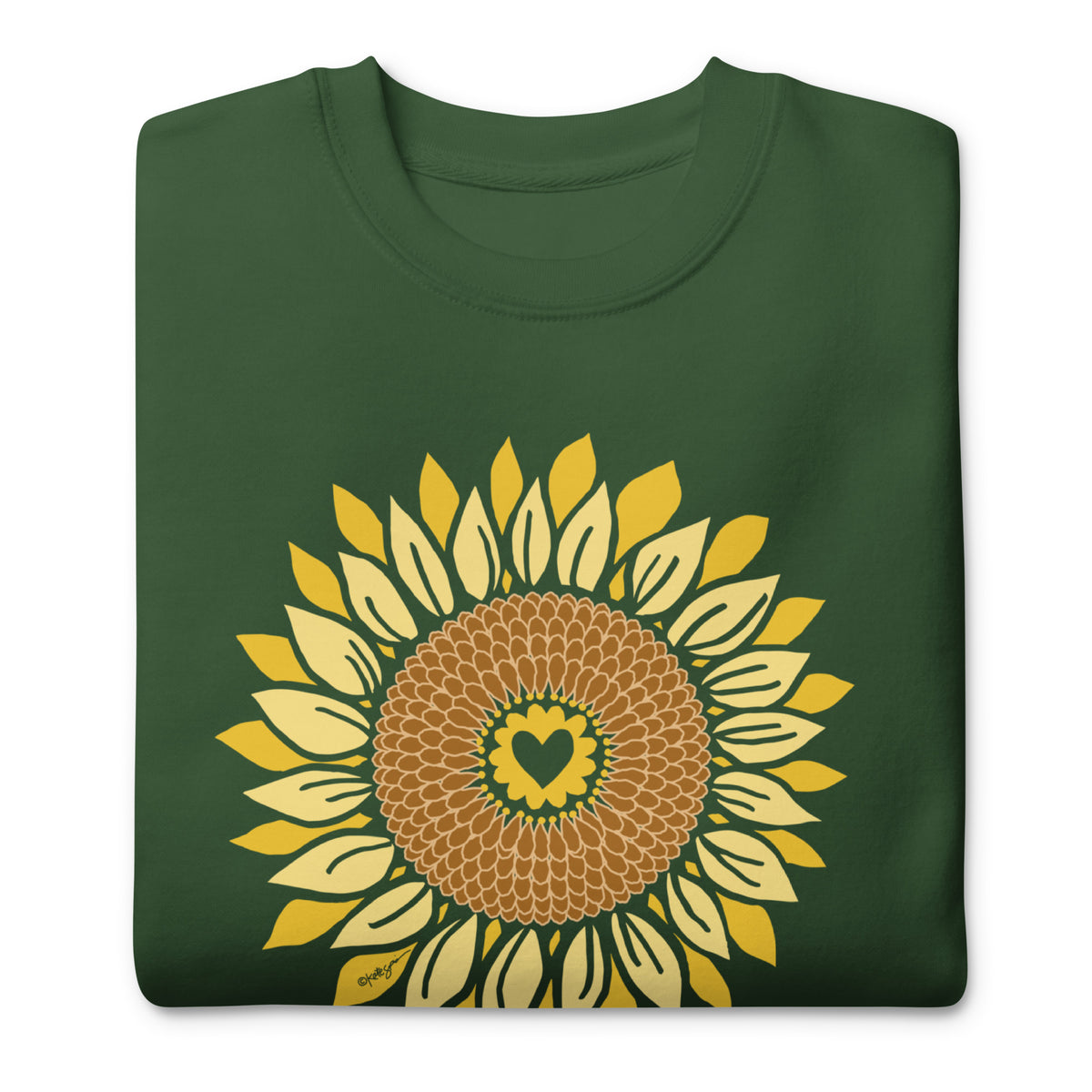 Golden sunflower with a heart center on a crewneck sweatshirt in forest green, folded close-up of the design – Sunflowers in My Heart by Kate Spain