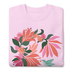 Hummingbird among coral tropical flowers on a crewneck sweatshirt in lavender, folded close-up of the design – Kate Spain design