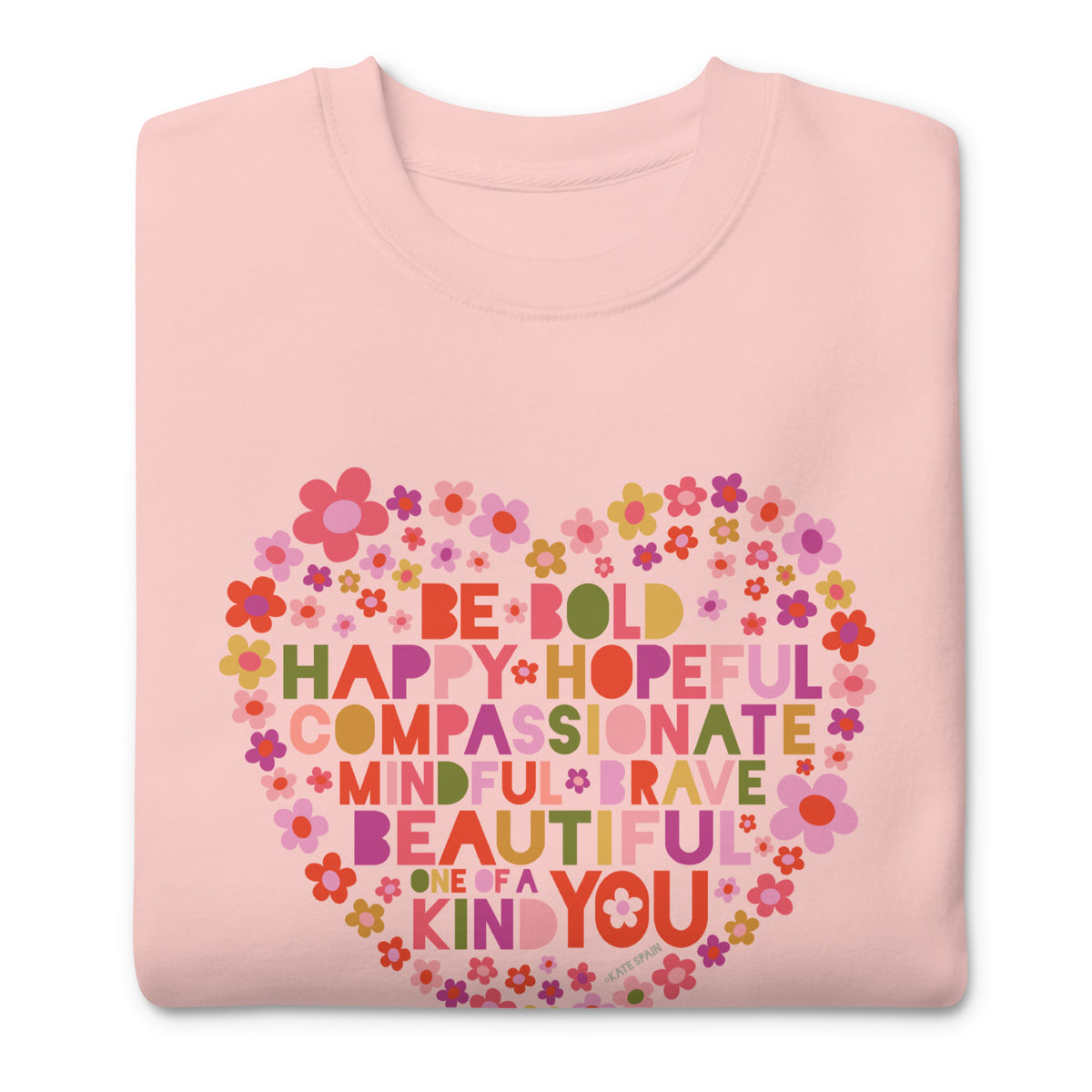 Be You floral heart of inspirational words on a premium sweatshirt in pink, folded close-up of the design – Kate Spain design